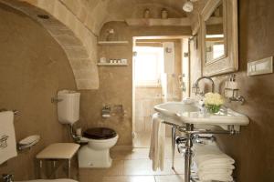 a bathroom with a sink and a toilet at Hotel Don Ferrante in Monopoli