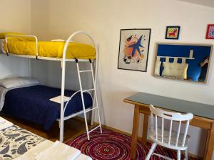 a bedroom with a bunk bed and a desk at Villa Capuano B&B in Camigliatello Silano