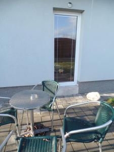a table and chairs on a patio with a window at Apartmány City in Ostrava