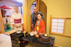 a group of three people standing in a room at Morizuya in Toyooka