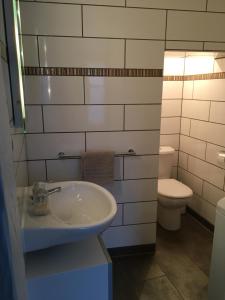a bathroom with a sink and a toilet at Huna’gîte in Hunawihr +25 photos