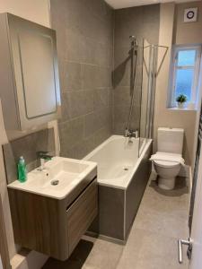 a bathroom with a sink and a tub and a toilet at Biskey Howe flat - FREE off-site Health Club access with Pool, Sauna, Steam Room & Gym in Windermere