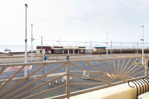 a view of a parking lot with a metal railing at Queens Mansions: Ocean View Apartment in Blackpool