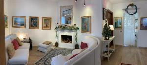 a living room with white couches and a fireplace at Rana B&B in Ornago