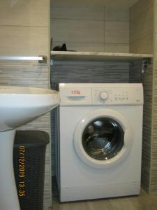 a washing machine in a bathroom next to a sink at Sicily Sun in Lentini