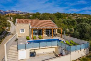 an aerial view of a house with a swimming pool at Villa Olivia - Jasenice, with swimming pool and jacuzzi in Jasenice
