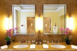 a bathroom with two sinks and a mirror at Hotel Le Plaza Brussels in Brussels