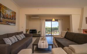 a living room with two couches and a table at Villa Katerina in Siviri