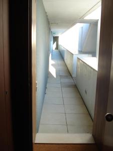 an empty hallway in an office building with ailed floor at Porto D´Ouro Apartments in Porto