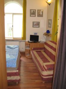 a bedroom with a bed and a desk with a computer at Zderaz in Prague