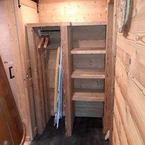 una casa pequeña con estanterías de madera en una habitación en Le Valmandine en La Bresse