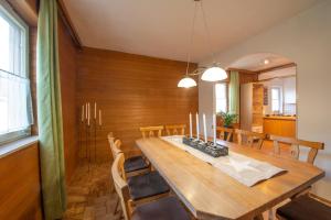 a dining room with a wooden table and chairs at Haus Karl in Ebensee