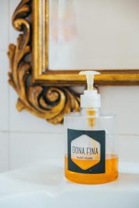 a bottle of dummy fire moisturizing soap in front of a mirror at Dona Fina Guest House in Mirandela