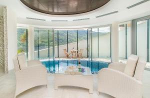 a living room with a pool with chairs and a table at Lavender Bay Apartments D3 or D5 I by Andreas Crivellaro in Donji Morinj