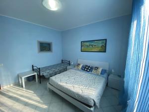 Postel nebo postele na pokoji v ubytování B&B Il Moai