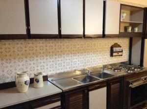 a kitchen with a sink and a counter top at Verdi Apartment in Castellammare del Golfo