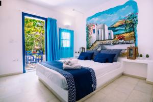 a bedroom with a large bed with a painting on the wall at Casa Di Roma in Parikia
