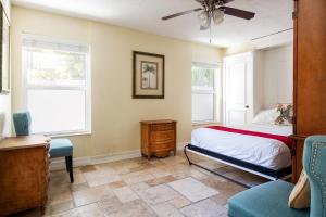 a bedroom with a bed and two windows at Home by Beach 3 - Delnor-Wiggins in Naples