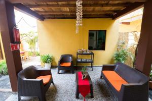 a patio with two chairs and a table at Papaya Lodge in La Libertad