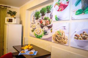 una cocina con fotos de plantas en la pared en ORNAVA Boutique Apartments, en Ternopilʼ