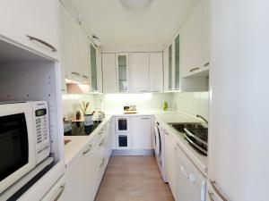 a white kitchen with white cabinets and white appliances at Bossa nova Castle&Outstanding home with garage in Ljubljana