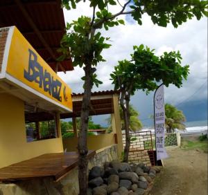 a restaurant with a tree in front of a building at Bananoz Surfhouse in Transito