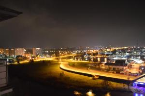 a view of a city at night with lights at Apartamenty Super Kołobrzeg in Kołobrzeg