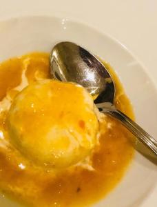 a bowl of yellow food with a spoon in it at La Trigola in Santo Stefano di Magra