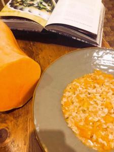 a plate of food on a table next to a book at La Trigola in Santo Stefano di Magra