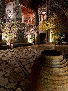 a stone building with a large vase in front of it at Elati's traditional and cosy home in Eláti
