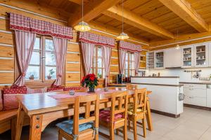 a kitchen and dining room with a wooden table and chairs at Svatá Panna in Loktuše