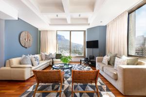 a living room with a couch and a table at #1804 Cartwright - Spacious and Elegant in Cape Town