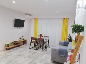 a living room with a couch and a table at Mezquita- Elite, Parking, Wifi in Córdoba