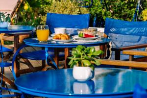 a blue table with a plate of food and drinks on it at Casa Di Roma in Parikia