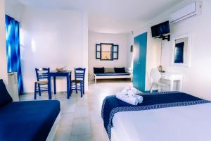 a bedroom with two beds and a living room at Casa Di Roma in Parikia