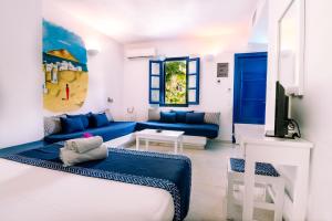 a living room with blue furniture and a blue couch at Casa Di Roma in Parikia