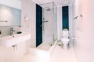 a bathroom with a toilet and a sink and a shower at Casa Di Roma in Parikia