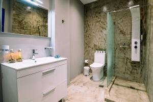 a bathroom with a sink and a toilet and a shower at Casa Di Roma in Parikia