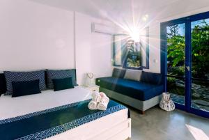 a bedroom with a bed and a couch and a window at Casa Di Roma in Parikia