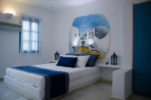 a bedroom with a bed with a painting on the wall at Casa Di Roma in Parikia