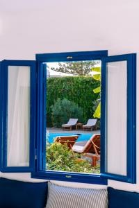 a window with a view of a swimming pool at Casa Di Roma in Parikia