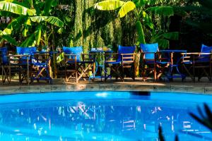 a group of chairs and tables next to a pool at Casa Di Roma in Parikia