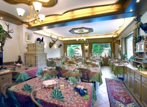 a dining room with long tables and chairs at Hotel Zoldana in Forno di Zoldo