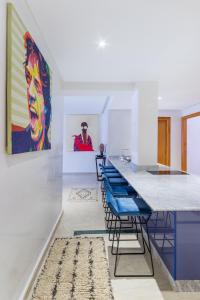 a room with blue chairs and a painting on the wall at Best for group, 5 min from medina in Marrakech