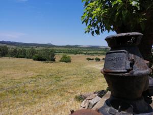 a fence with a tree on top of a field at La Chacra in Minas