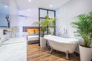 a bathroom with a tub and potted plants at Best for group, 5 min from medina in Marrakech
