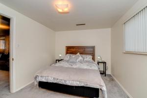 a bedroom with a large bed with white walls at Pet Friendly Sleeps 12 near Garden of the Gods AF in Colorado Springs
