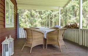 a patio with a table and chairs on a porch at 1 Bedroom Cozy Home In Torup in Torup