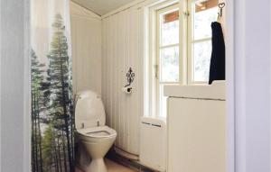 a bathroom with a toilet and a window at 1 Bedroom Cozy Home In Torup in Torup