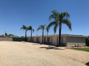 a building with palm trees in front of it at Jerilderie Motor Inn in Jerilderie